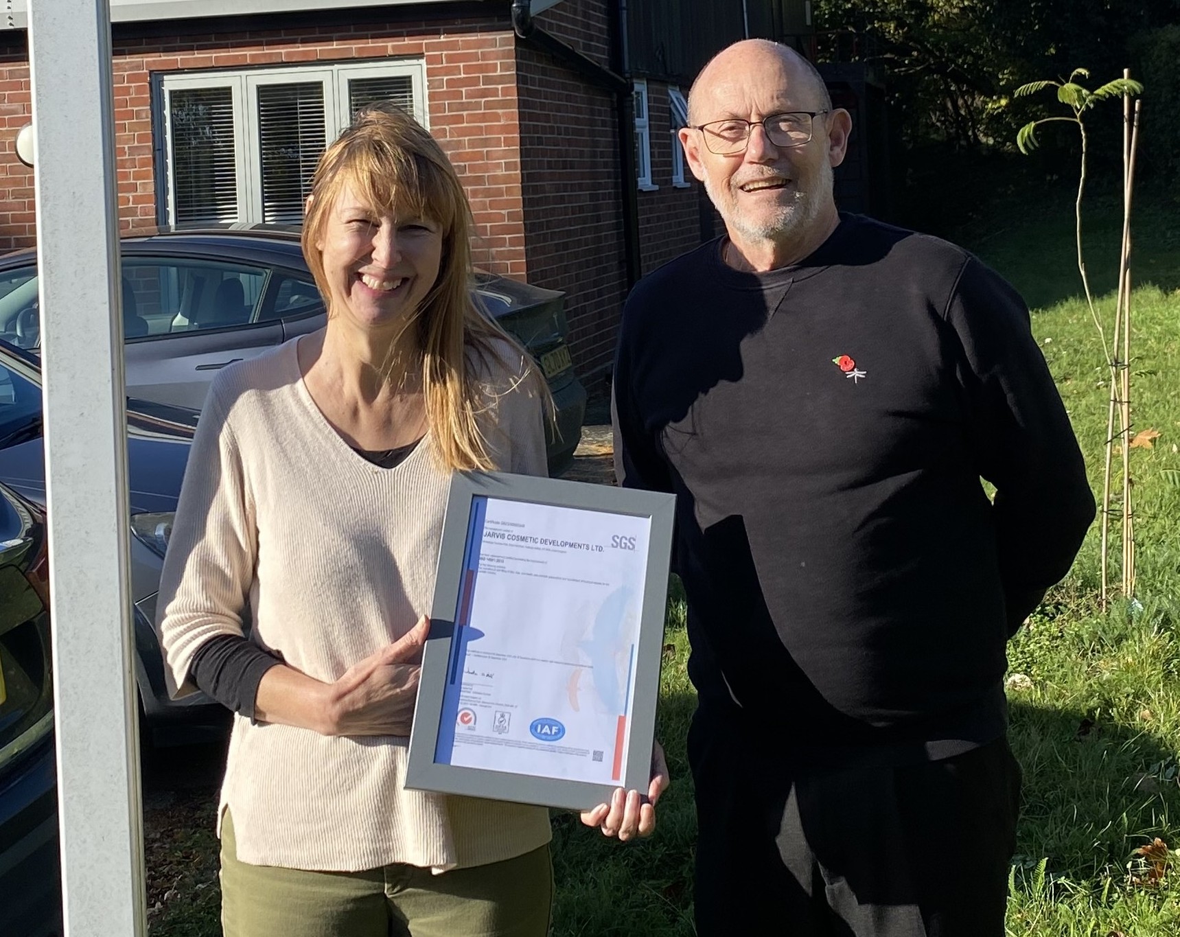 Suzanne Deacon, QA Manager at Jarvis, holding an award alongside Mike, Business/Finance Manager, celebrating ISO 14001 certification.